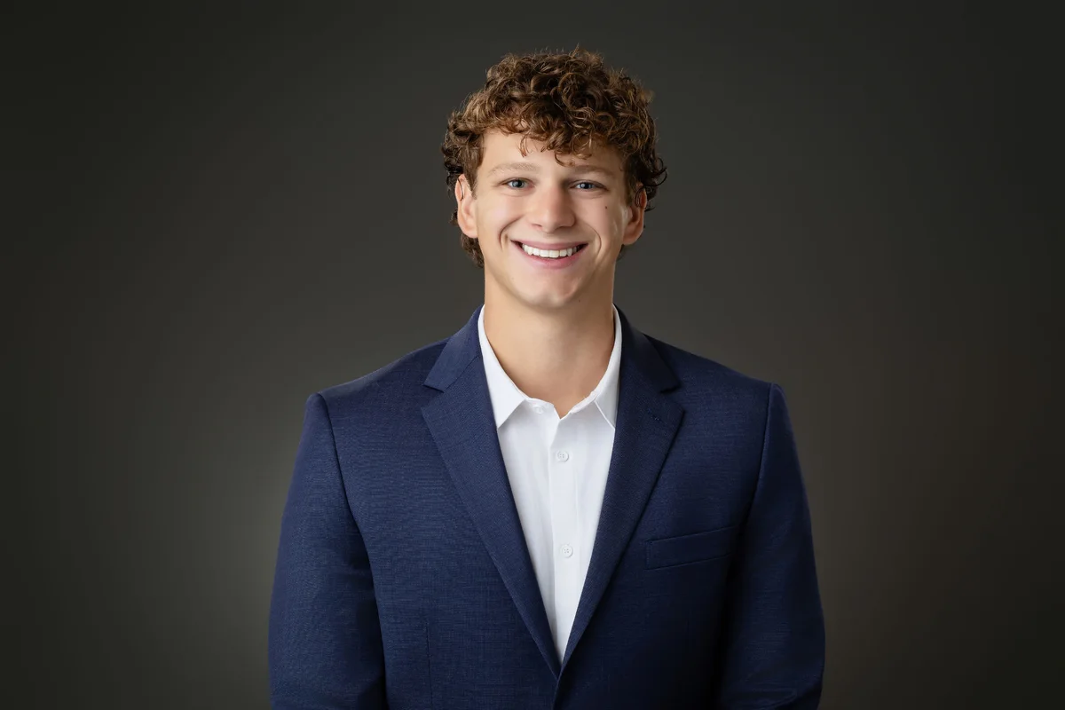 Nathan Ockrim, founder of Good Neighbor Crew, smiling in a navy jacket